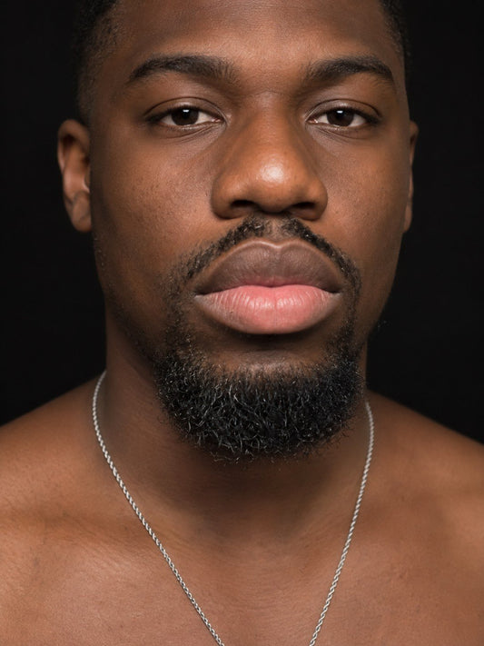 Man facing the camera, upper lip darker than the lower lip